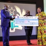 President Akufo-Addo presenting a cheque of 100,000 to the Makola Traders Association