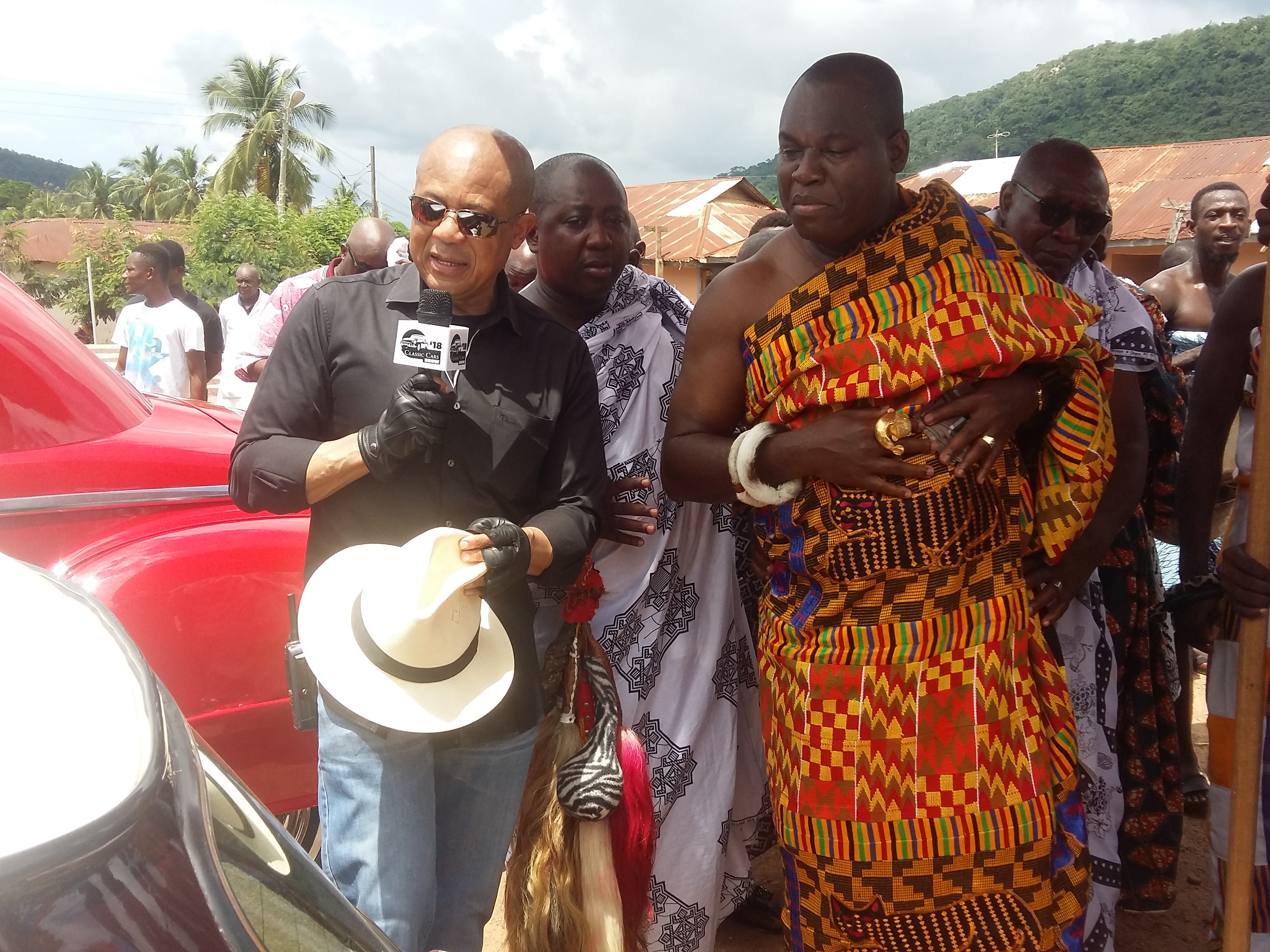 Akwamuhene Odeneho Kwafo Akoto II being shown the cars