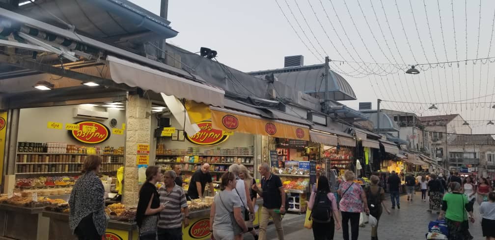 There are several tourists at the Yehuda Market