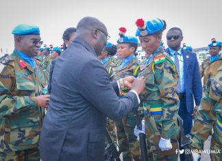 Dr. Bawumia pinning medals on troops at a colourful ceremony