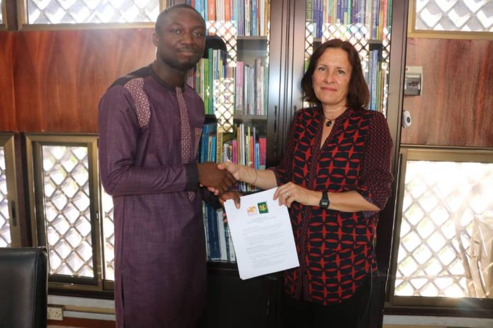 Mr. Siaw of GhLA and Madam Tweed of Book Aid International after signing the pact