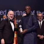 Awal Mohammed displaying the award