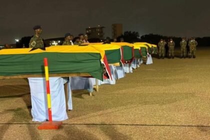 Caskets of helicopter crash victims received at Air Force Base with military honours
